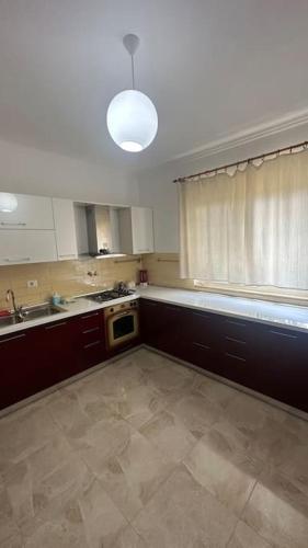 an empty kitchen with a sink and a window at Tranquil Lakehouse in Shkodër