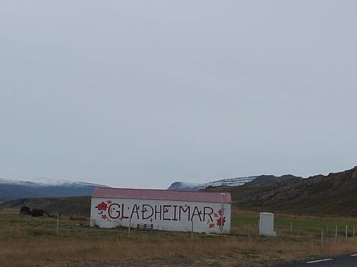a sign on the side of a road at Ásbrandsstadir Cottages in Vopnafjörður