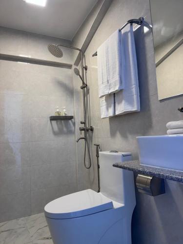 a bathroom with a toilet and a sink and a shower at INFINITE LAGOON in Mandhoo