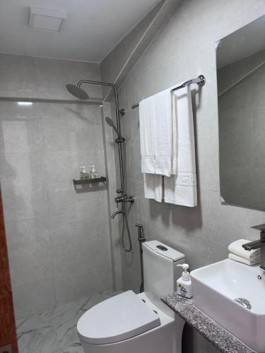 a bathroom with a shower and a toilet and a sink at INFINITE LAGOON in Mandhoo