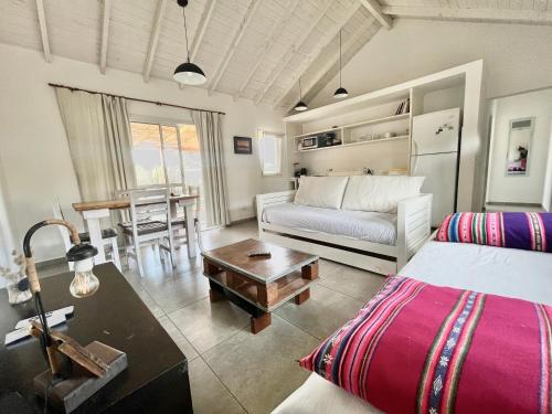 a living room with a couch and a table at Casas Criollas in Chapadmalal