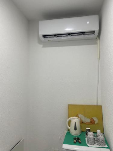 a room with a air conditioner on a wall at Unik Family Only Apartments in Prizren
