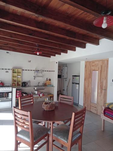 a kitchen with a table and chairs in a room at La Corzuela in Lozano