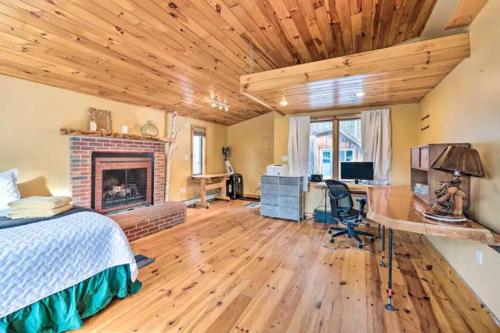 a bedroom with a bed and a desk and a fireplace at NEW! White Mountains View Escape in Campton Upper Village