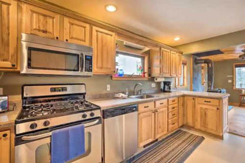 a kitchen with a stove and a microwave at NEW! White Mountains View Escape in Campton Upper Village
