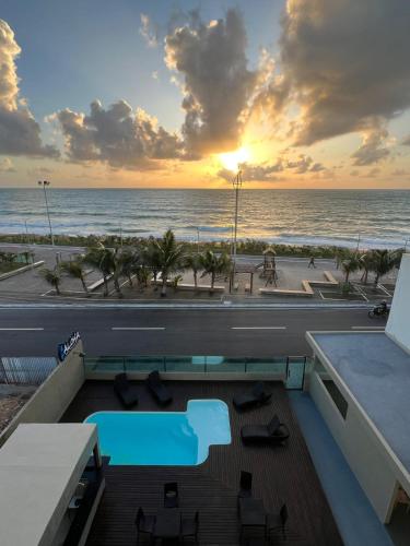 a view of the ocean from the balcony of a resort at Aloha Pousada Maceió in Maceió