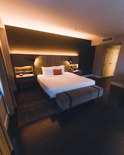 a bedroom with a large white bed in a room at The Delaney Hotel in Orlando
