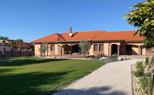 a house with a green lawn in front of it at Bahama apartments in Bucsuháza