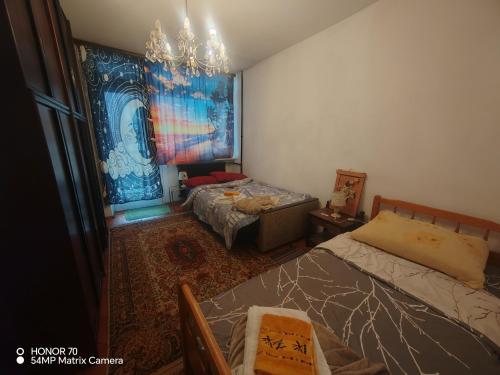 a bedroom with two beds and a chandelier at Apartments with parking space Bjelovar, Bjelovarska - 23322 in Bjelovar
