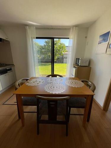 a table and chairs in a kitchen with a window at Hiei Mountain House in Otsu