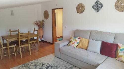 a living room with a couch and a table at Alojamento 3 vistas in Sintra