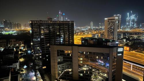 a view of a city at night with buildings at Horizon View Partition Room in Barsha Heights Near Metro in Dubai