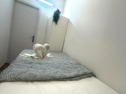 a room with a bed with two stuffed animals on it at Horizon View Partition Room in Barsha Heights Near Metro in Dubai