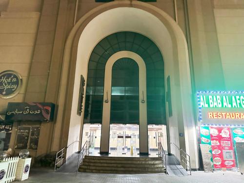 a large entrance to a building with stairs in front at Horizon View Partition Room in Barsha Heights Near Metro in Dubai
