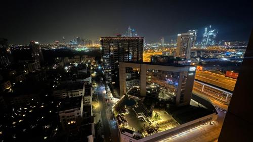 a view of a city at night with buildings at Horizon View Partition Room in Barsha Heights Near Metro in Dubai