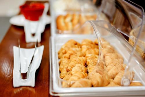 two plastic trays of donuts on a table at Shin Shin Hotel Jeju City in Jeju
