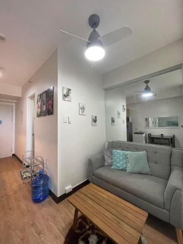 a living room with a couch and a coffee table at 1 BR Condo with balcony in Verdon Parc with Sea View in Sanghay