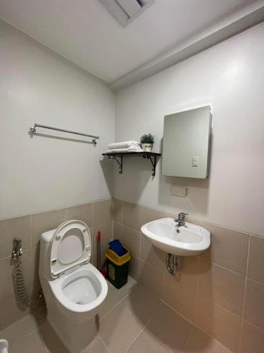 a bathroom with a toilet and a sink at 1 BR Condo with balcony in Verdon Parc with Sea View in Sanghay