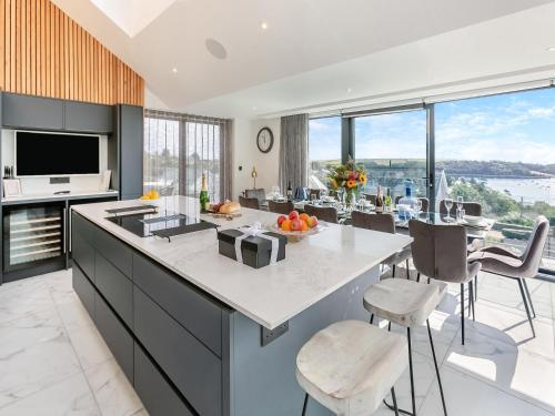a kitchen with a large island with a counter top at Seabreeze in Saint Mawes