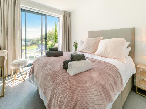 a bedroom with a bed with two towels on it at Seabreeze in Saint Mawes