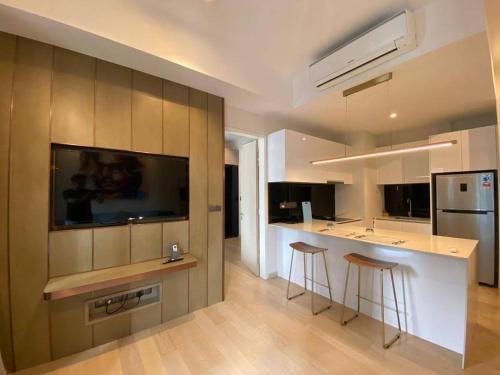 a kitchen with a bar and two stools in it at STAR RESIDENCE KLCC By GANTYA in Kuala Lumpur