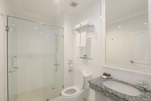 a bathroom with a toilet and a shower and a sink at Casa Blanca Boutique Hotel - SHA Plus in Phuket Town
