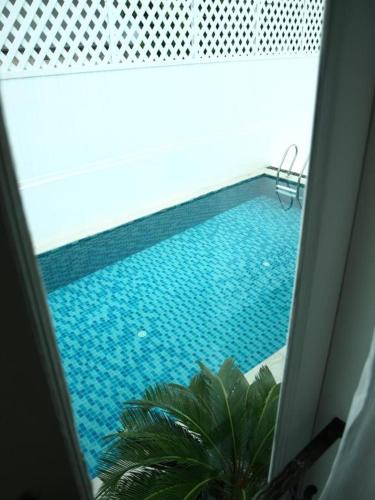 a view of a swimming pool from a window at Casa Blanca Boutique Hotel - SHA Plus in Phuket Town