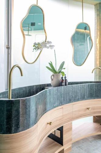 a bathroom with a sink and two mirrors at Uniquely designed 1bd villa with Pvt Pool in Umalas