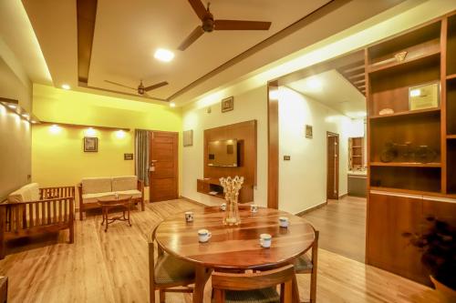a living room with a table and a couch at The Haven by Xplore Indo in Ooty