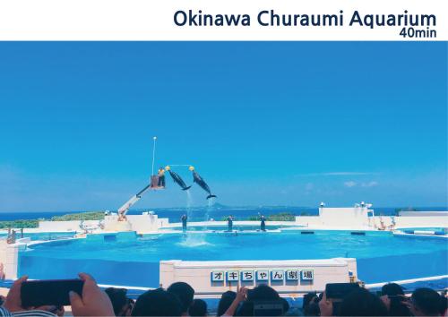 a group of people watching two people jumping in the air at NEW OPEN!Popular beaches are within a 5minute walk in Inbu