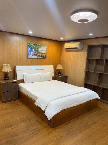 a bedroom with a large bed and two night stands at Binh An Hotel in Ho Chi Minh City