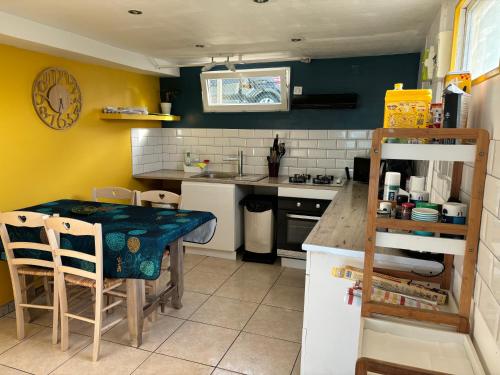 une cuisine avec une table et un comptoir dans l'établissement THE LOK, à Vassonville