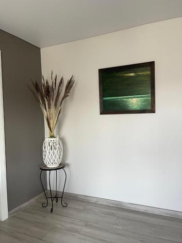a vase sitting on a table in a room at Few Steps to the Bay in Jūrmala