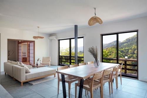 a living room with a table and a couch at プライベートリゾート日暖 in Taga