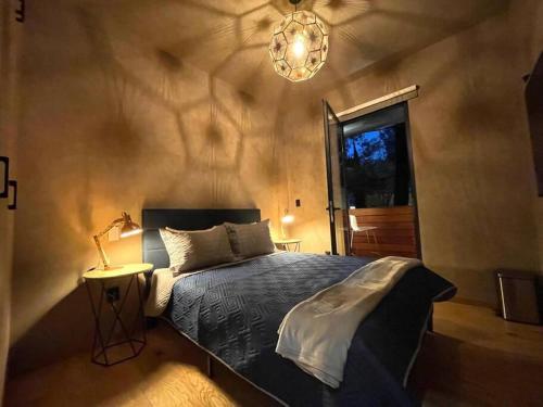 a bedroom with a bed and a lamp and a window at Casa Roma in Mexico City