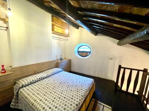 a bedroom with a bed and a round window at Casa Matilde in Bassano in Teverina