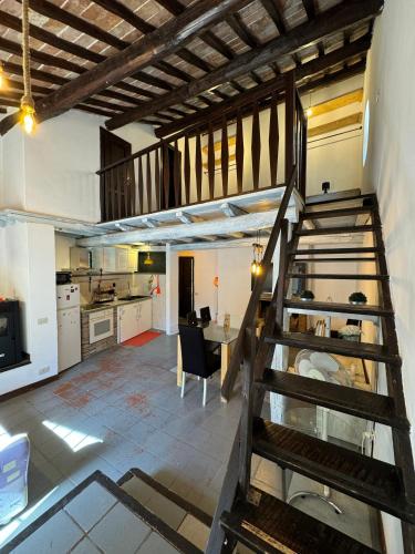 a kitchen and dining room with a staircase in a house at Casa Matilde in Bassano in Teverina