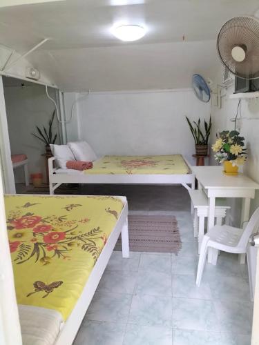 a room with two beds and a table at Cronin Residence Resort in Caceres