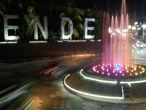 a fountain in the middle of a street at night at Rezka Roomz Syari'ah in Ende