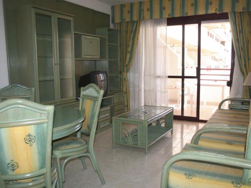 a room with a table and chairs and a window at Apartamentos Zafiro Unitursa in Calpe