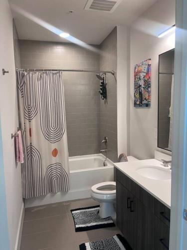 a bathroom with a shower and a toilet and a sink at central located Modern west Midtown suite in Atlanta