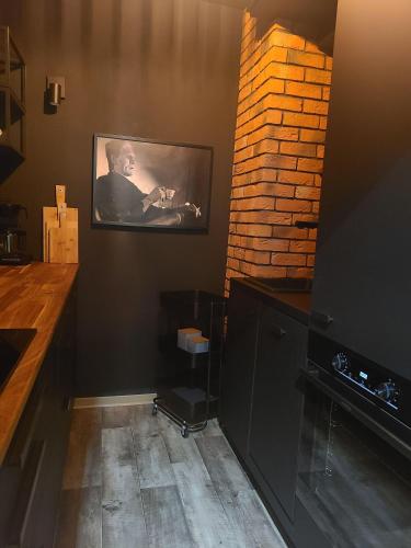 a living room with a tv on a brick wall at Luchshuette in Sankt Andreasberg