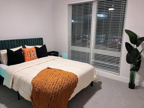 a bedroom with a bed and a large window at central located Modern west Midtown suite in Atlanta