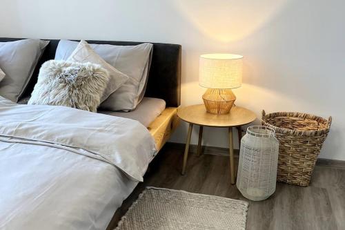 a bedroom with a bed and a table with a lamp at Apartmán Masaryk Square in Děčín