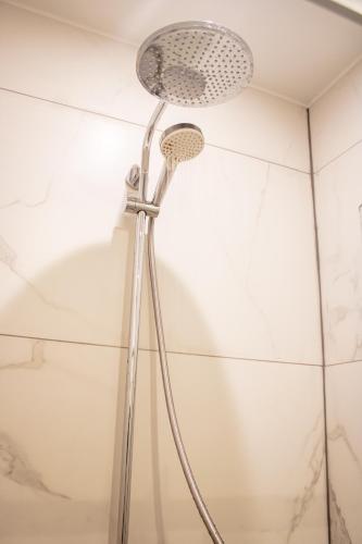 a shower in a bathroom with a shower head at Studio Bethel in Liège