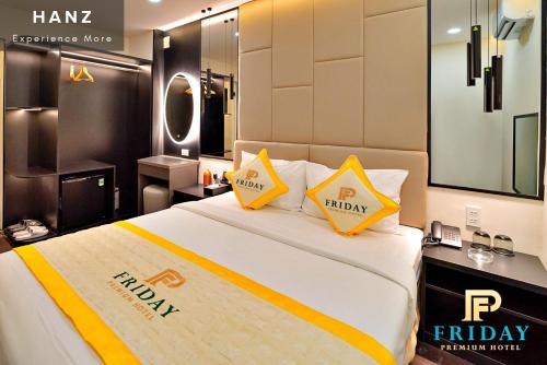a hotel room with a bed with yellow pillows at S79 Premium Friday Saigon in Ho Chi Minh City
