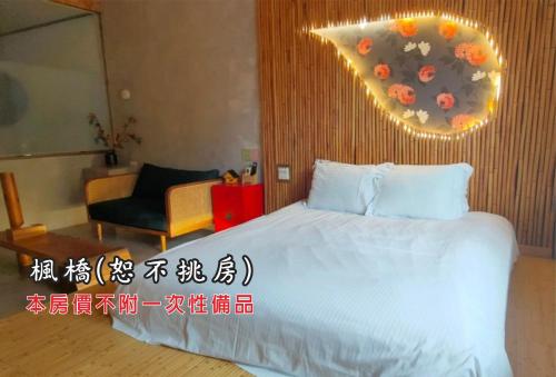 a hotel room with a bed and a chair at Tingtau Villa in Lugu