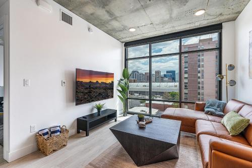 a living room with a couch and a table at Exceptional 1BD BA-PoolHotTubGymParking- Downtown! in Salt Lake City