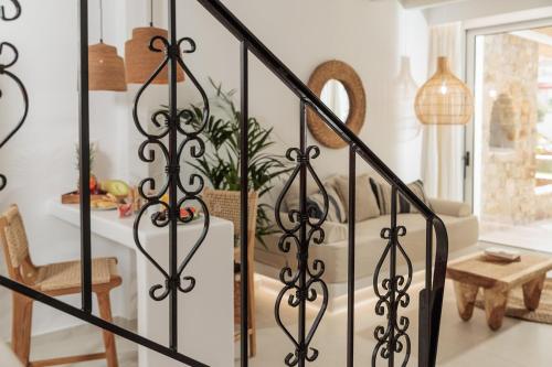 a staircase with black wrought iron railings at Country Villas in Stelida