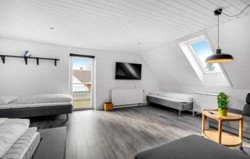 a living room with two beds and a table at Det gamle forsamlinghus in Struer
